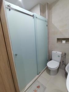 a bathroom with a toilet and a glass shower stall at Edy's STD04 in Imsouane