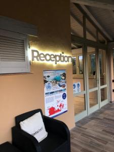 a room with a chair and a sign on the wall at Gravina Resort & Apartments in Costa Paradiso