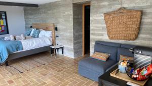 a living room with a bed and a couch at El jardin Botánico Villa LUZ in Altea