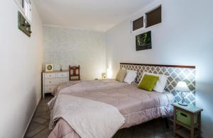 a bedroom with a large bed and a night stand at Apartment in a House in Tavira