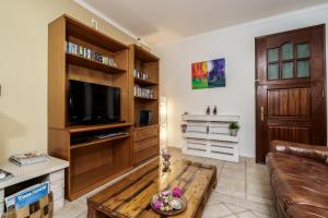 a living room with a couch and a flat screen tv at Apartment in a House in Tavira