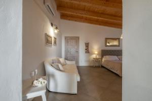 a living room with a couch and a bed at Dimoras Boutique Rooms in Olbia
