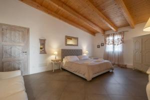 a bedroom with a large bed and a window at Dimoras Boutique Rooms in Olbia +48 photos