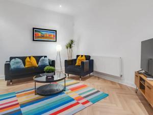a living room with two couches and a coffee table at Pass the Keys Golfers Haven 2 BD Flat on Hoylake Beach Parking in Hoylake