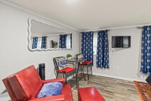 a living room with red chairs and a table at Guest House In The Heart Of Watkins Glen in Watkins Glen