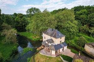 an aerial view of a house on a river at Le Moulin des Rives - Somptueuse demeure du XIIème in Romagne