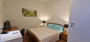 a small bedroom with a bed and a desk at Attico Mexico in Pescara