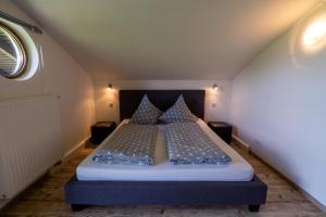 a bedroom with a bed with blue sheets and pillows at Villa Pia in Reit im Winkl