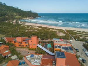 an aerial view of a beach with houses and the ocean at Ferrujão Pousada e Restaurante in Garopaba