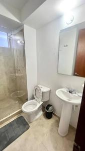a bathroom with a toilet and a sink and a shower at Apto cómodo en conjunto 1 piso parqueadero in Sogamoso +5 photos