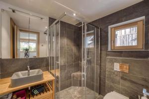 a bathroom with a sink and a shower at Chalet 124 in Chamonix +22 photos