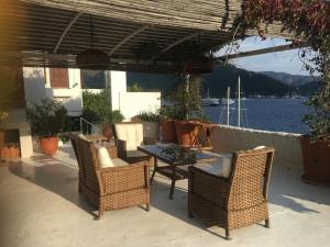 a patio with a table and chairs and a view of the water at Castle81homes Blue - Sea view house in Marmaris +7 photos