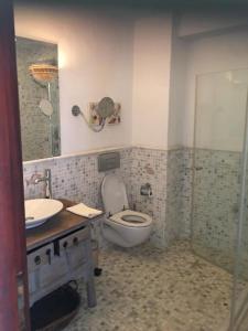 a bathroom with a toilet and a sink and a shower at Castle81homes Blue - Sea view house in Marmaris