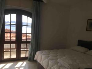 a bedroom with a bed and a large window at Castle81homes Blue - Sea view house in Marmaris