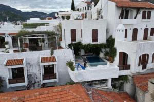 a man standing on top of a white building at Castle81homes Blue - Sea view house in Marmaris