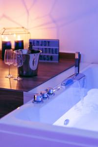 een badkamer met een bad met 2 wijnglazen bij Effedi Loft in Barletta