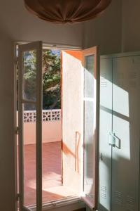 an open door of a room with a balcony at Charmante maison familiale vue sur mer in Marseille