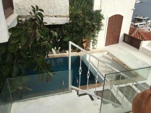 a balcony with a glass railing next to a pool at Castle81homes Pink - Sea view house in Marmaris