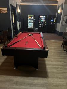 a pool table with two cuesticks on top of it at West Rocks Townhouse in Eastbourne