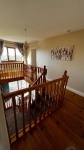 a wooden staircase in a room with wooden floors at BARR AN CHNOIC HOLIDAY LETTINGS in Tipperary
