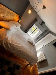 a large bed in a room with a window at Old Manor House in Axbridge