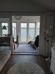 a woman laying in a chair in a living room with the ocean at Vakantiepark Klein Vink - Boulevard 16 in Arcen