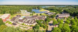 an aerial view of a large building with a lake at Vakantiepark Klein Vink - Boulevard 16 in Arcen