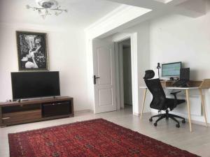 a room with a desk with a computer and a chair at Castle81homes Red, sea view central flat in Marmaris
