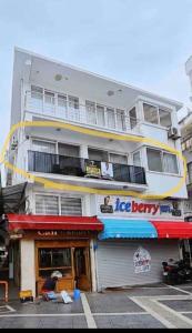 a building with a woman sitting in front of it at Castle81homes Red, sea view central flat in Marmaris +4 photos