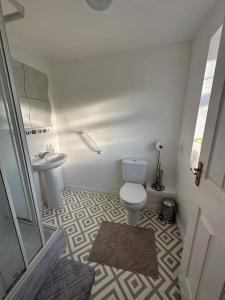 a bathroom with a toilet and a sink at Spacious & Lovely 4 Bedroom Home in Manchester in Manchester