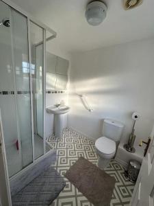 a bathroom with a shower and a toilet and a sink at Spacious & Lovely 4 Bedroom Home in Manchester in Manchester