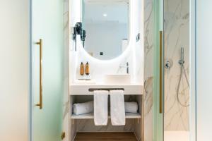 a bathroom with a sink and a mirror at Hotel Málaga Vibes in Málaga