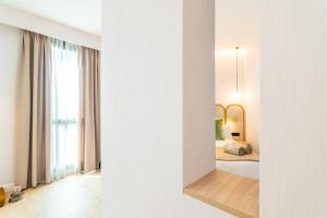 a view of a bedroom with a bed and a mirror at Hotel Málaga Vibes in Málaga