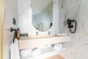 a bathroom with a sink and a mirror at Hotel Málaga Vibes in Málaga