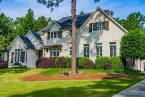 una casa blanca con un árbol en el patio en Sleeps 14 - Pinehurst, en Pinehurst