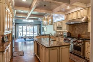 a large kitchen with wooden cabinets and a large island at Sleeps 14 - Pinehurst in Pinehurst