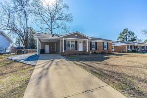 a brick house with a driveway in front of it at Fayetteville Home Away from Home, Pet Friendly in Fayetteville