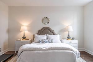 a bedroom with a large white bed with two lamps at Sleeps 6-Southern Pines in Southern Pines