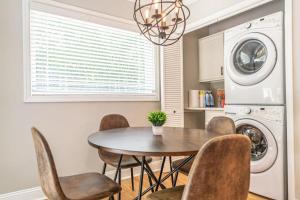a kitchen with a table and chairs and a washer and dryer at Maine Avenue- Downtown Southern Pines in Southern Pines