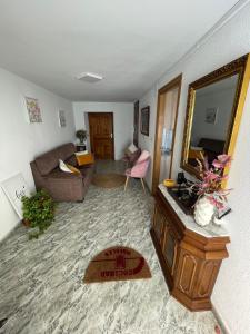 a living room with a couch and a mirror at Casa da Torre 