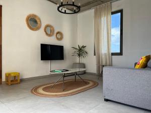 a living room with a tv and a couch at Cosy Apartment in Pereybere - Season Break in Pereybere