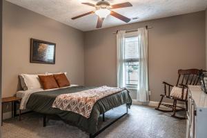 a bedroom with a bed and a ceiling fan at Sleeps 8- in Carthage in Carthage