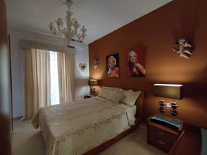 a bedroom with a bed and two pictures on the wall at Tal-Munfuha- Centrally Located Space. in Valletta