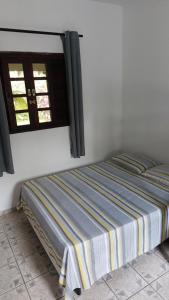 Postel nebo postele na pokoji v ubytování Maury Chalés Boiçucanga