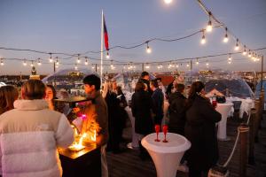 a group of people standing around tables with lights at Pytloun Boutique Hotel Prague in Prague