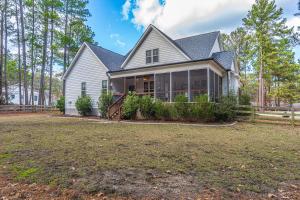 a house with a large yard at Sleeps 8-Whispering Pines 