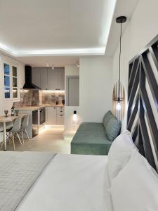 a living room with a couch and a kitchen at Pansion Episkopi Studios in Skopelos Town
