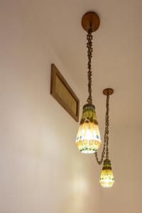 two chandeliers hanging from the ceiling in a room at Hotel Casa do Bispo in Manaus