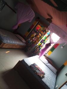 a room with a bed and a stained glass window at Akomapa Village in Elmina