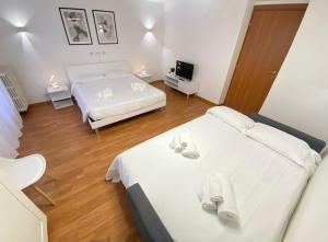 a bedroom with two beds and a television in it at Casa Relax 120 MQ con Metro in Rome